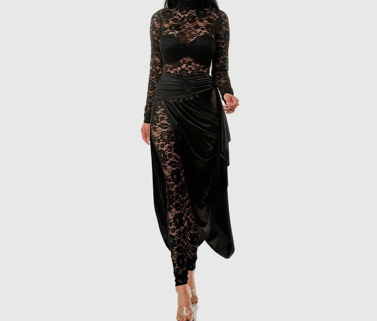 Black lace dress with a draped design on a white background