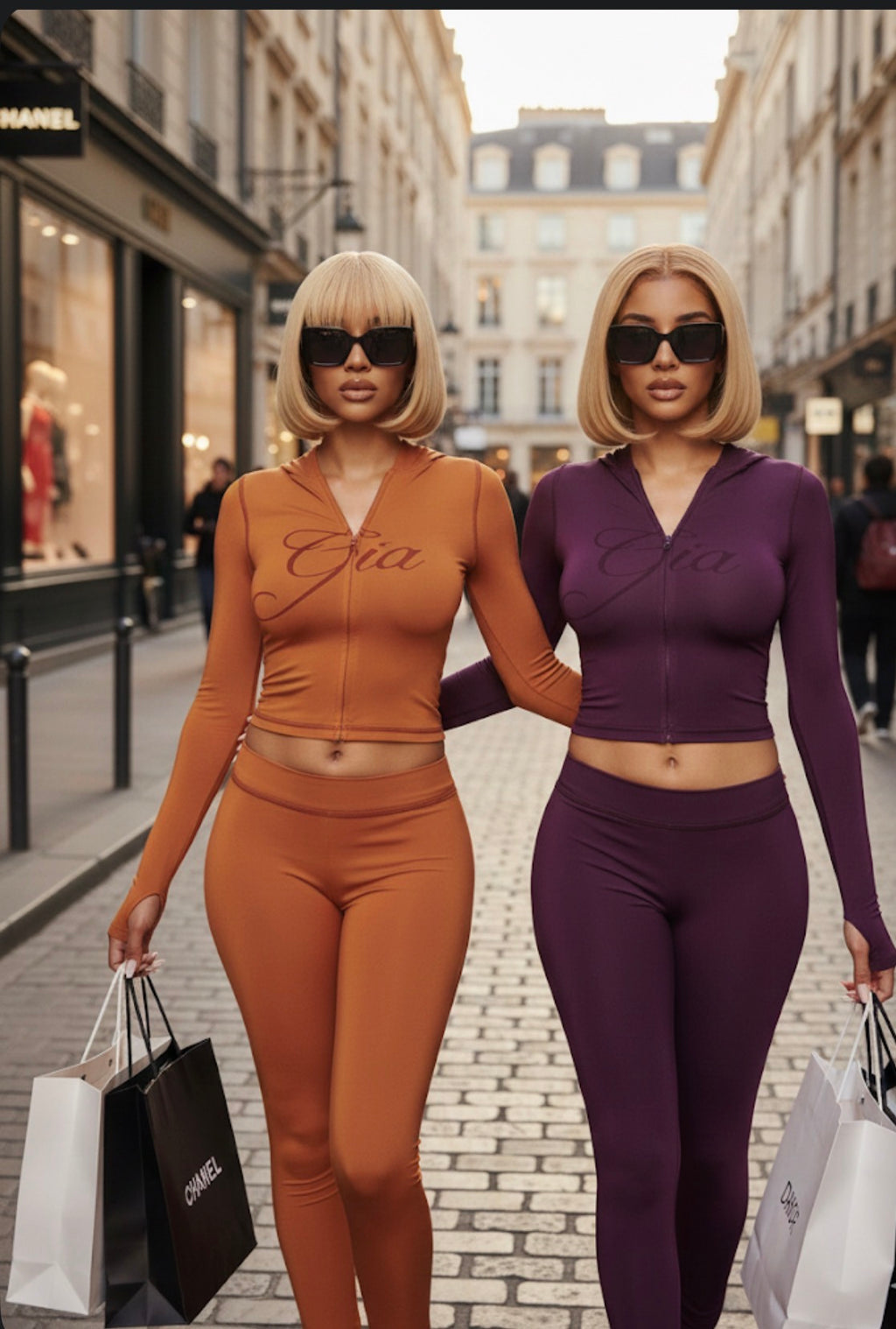 Two women in matching outfits with shopping bags on a city street.